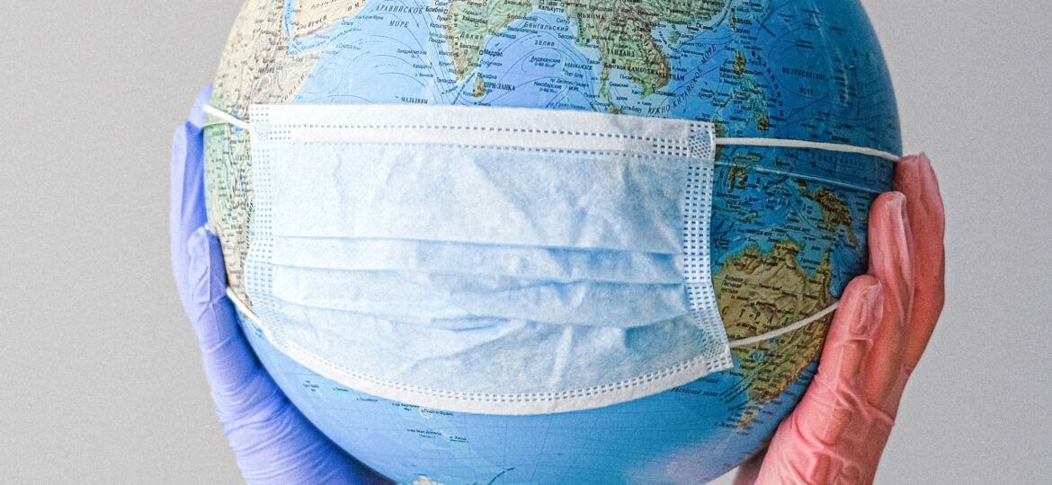 hands-with-latex-gloves-holding-a-globe-with-a-face-mask-4167544 (Demo)